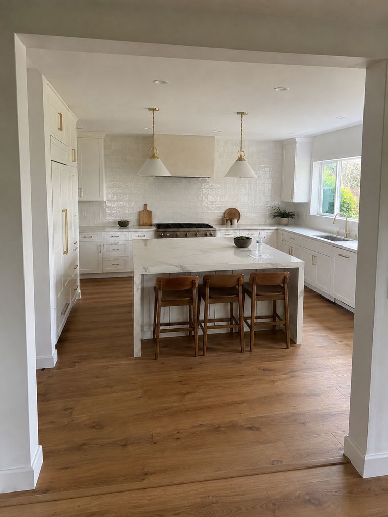 Kitchen viewed through a wide cased opening from the adjoining room