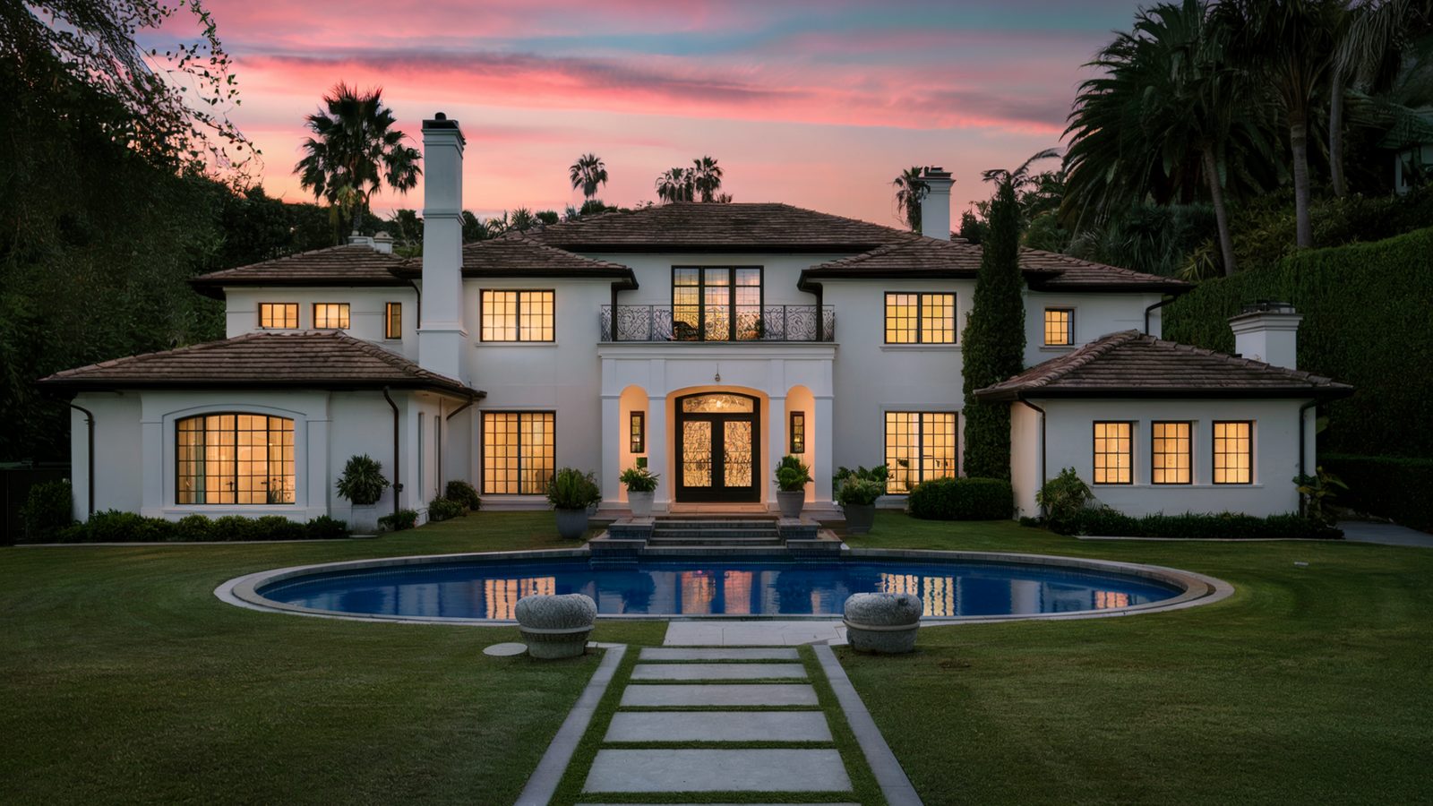 Completed home exterior with pool after a full remodel
